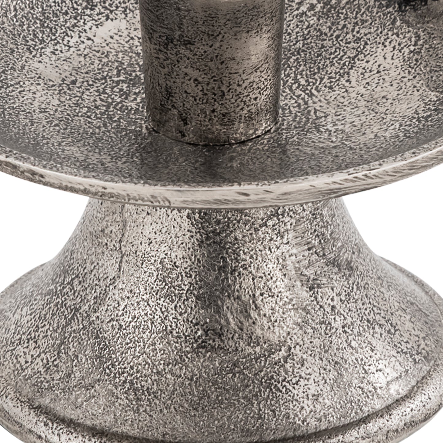 Close-up of a textured metal candle holder on a white background