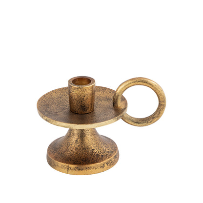Bronze candle holder with a round base and ring handle on a white background