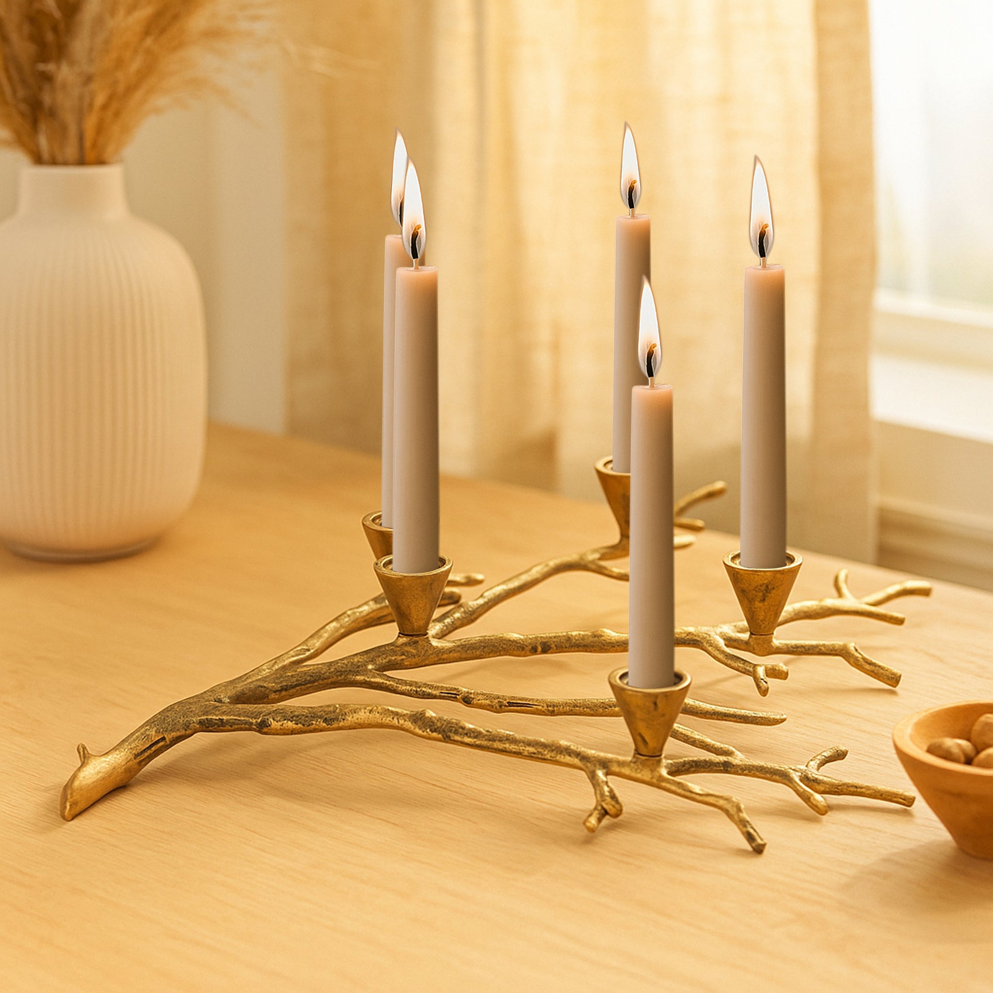 Decorative candle holder with five lit candles on a wooden surface.