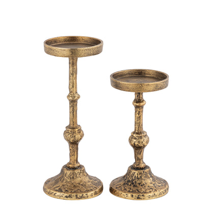 Two gold candle holders on a white background