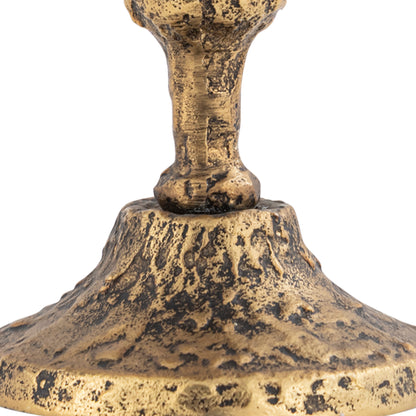 Vintage-style gold metal candle holder close-up on a white background