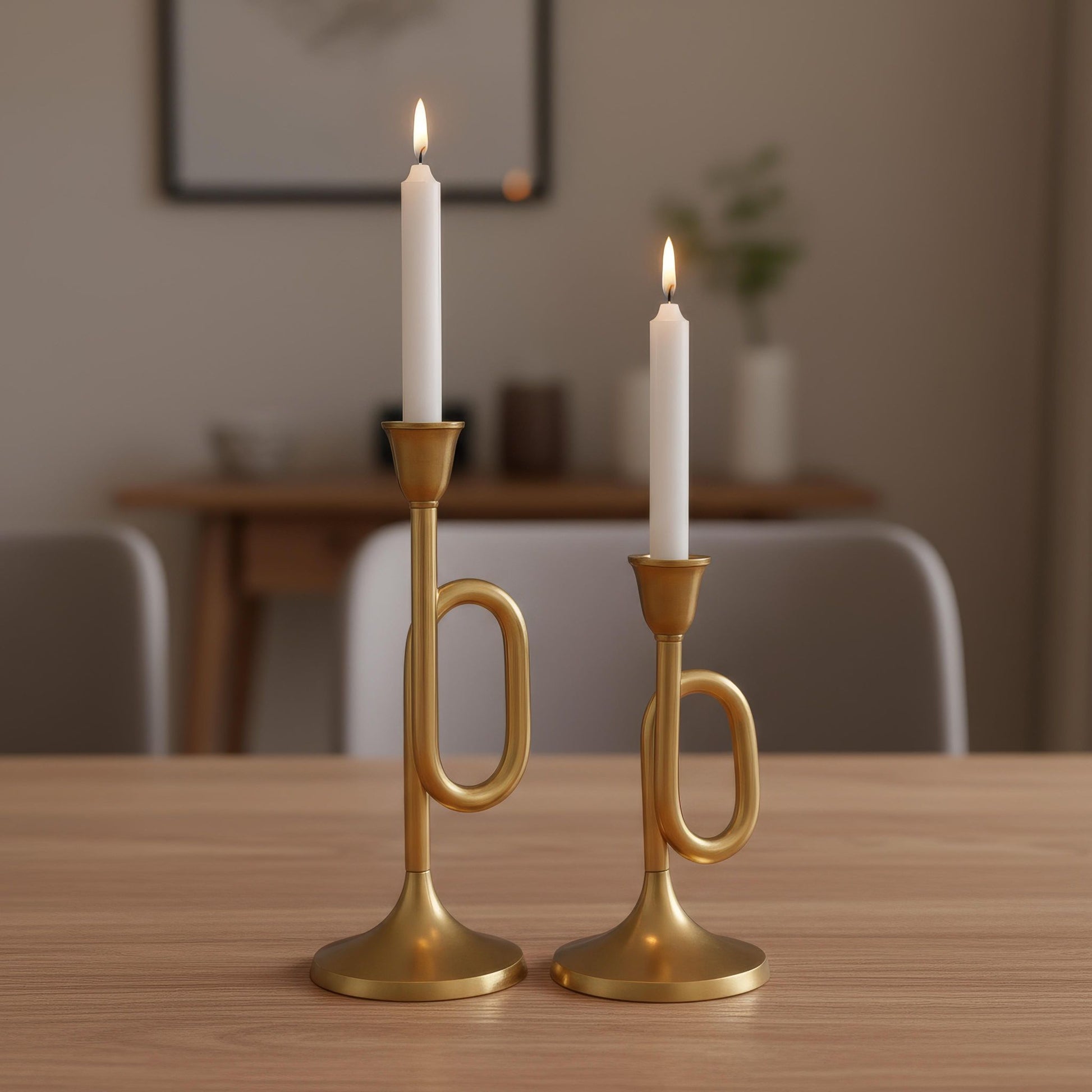Two gold candle holders with lit candles