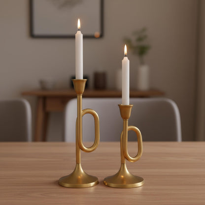 Two gold candle holders with lit candles