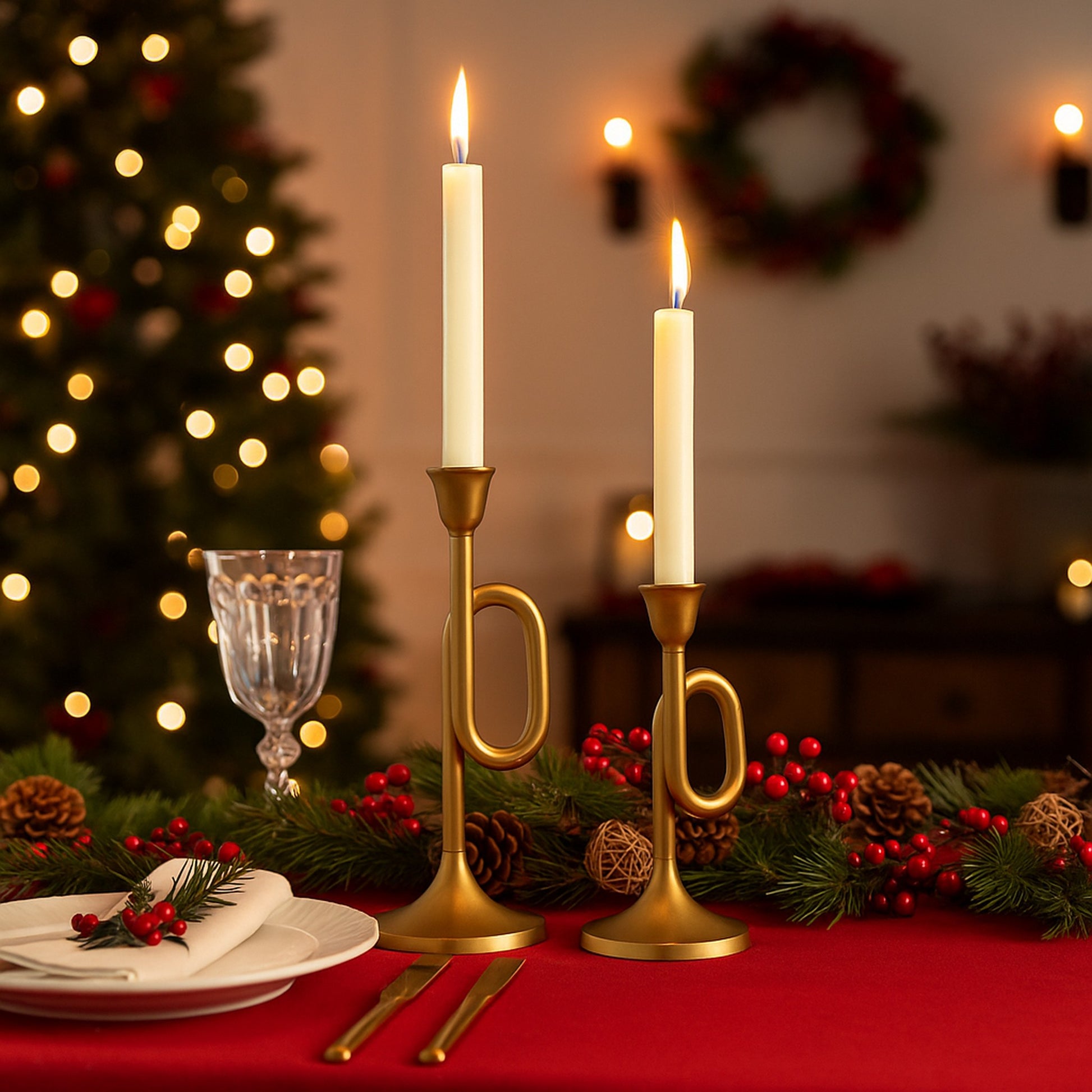 Two gold candle holders with lit candles