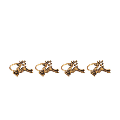 Four gold deer-shaped napkin rings on a white background
