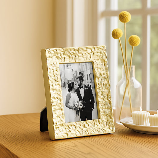 Gold textured picture frame with a photo of a couple