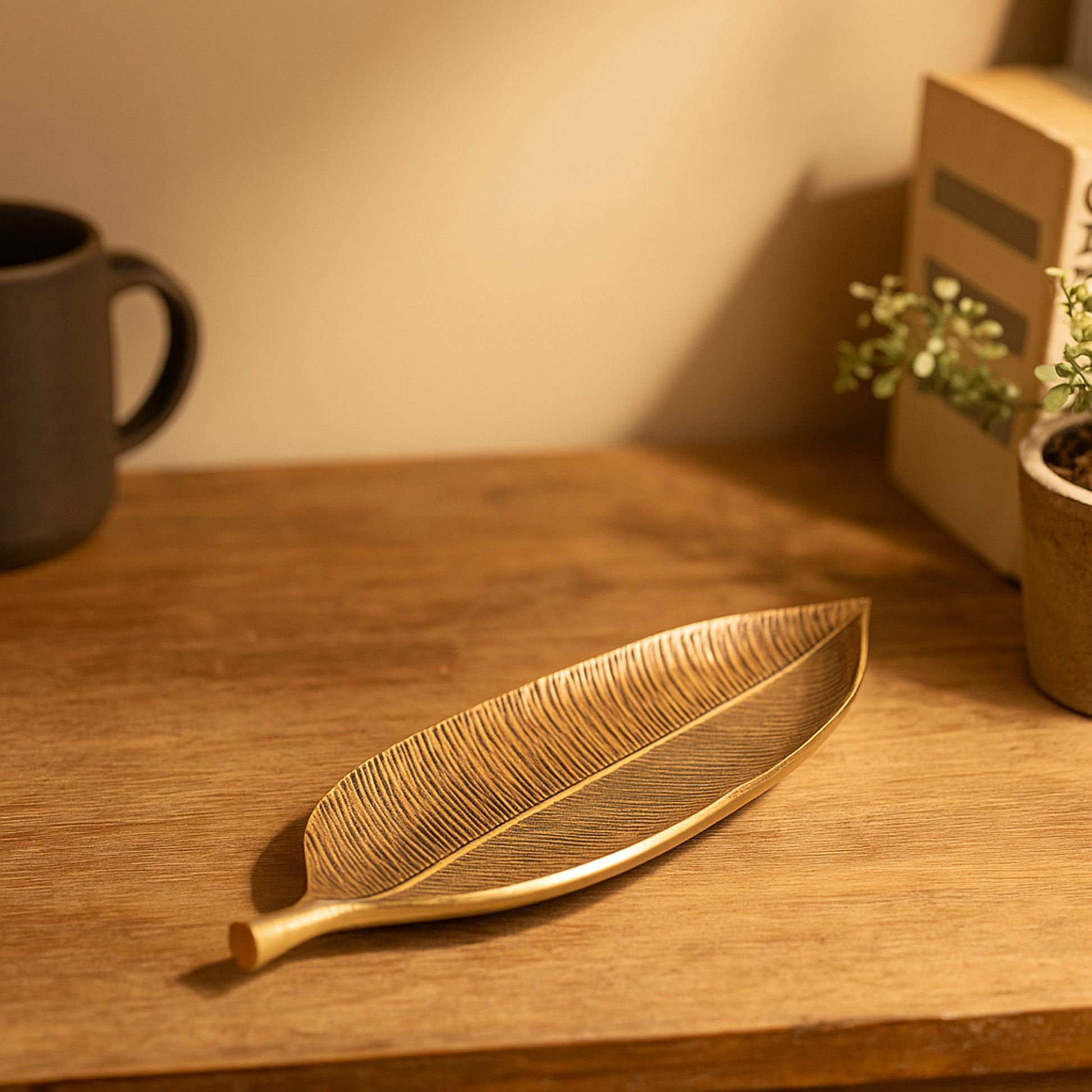Gold leaf-shaped tray on a wooden surface